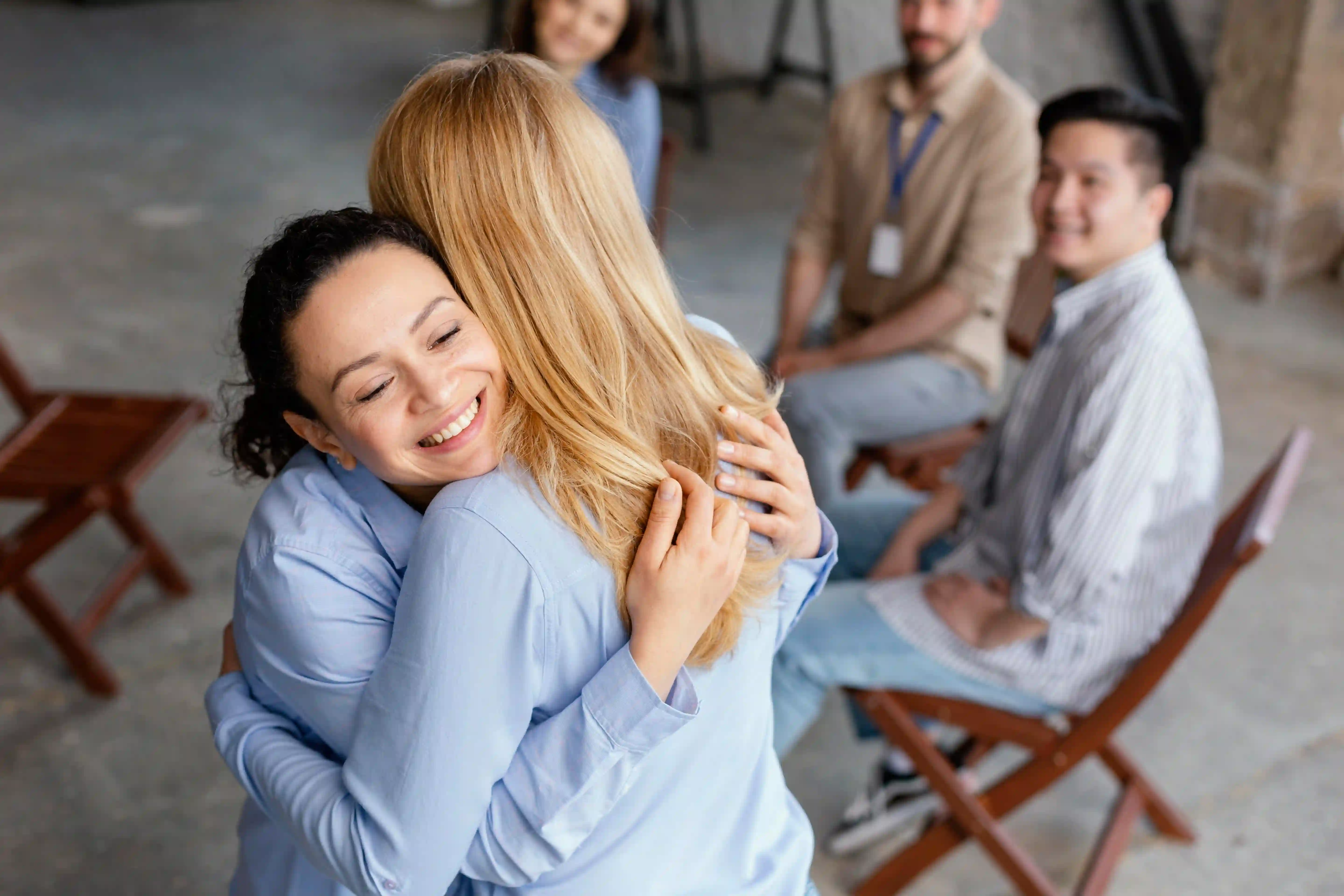 People embracing in front of one another