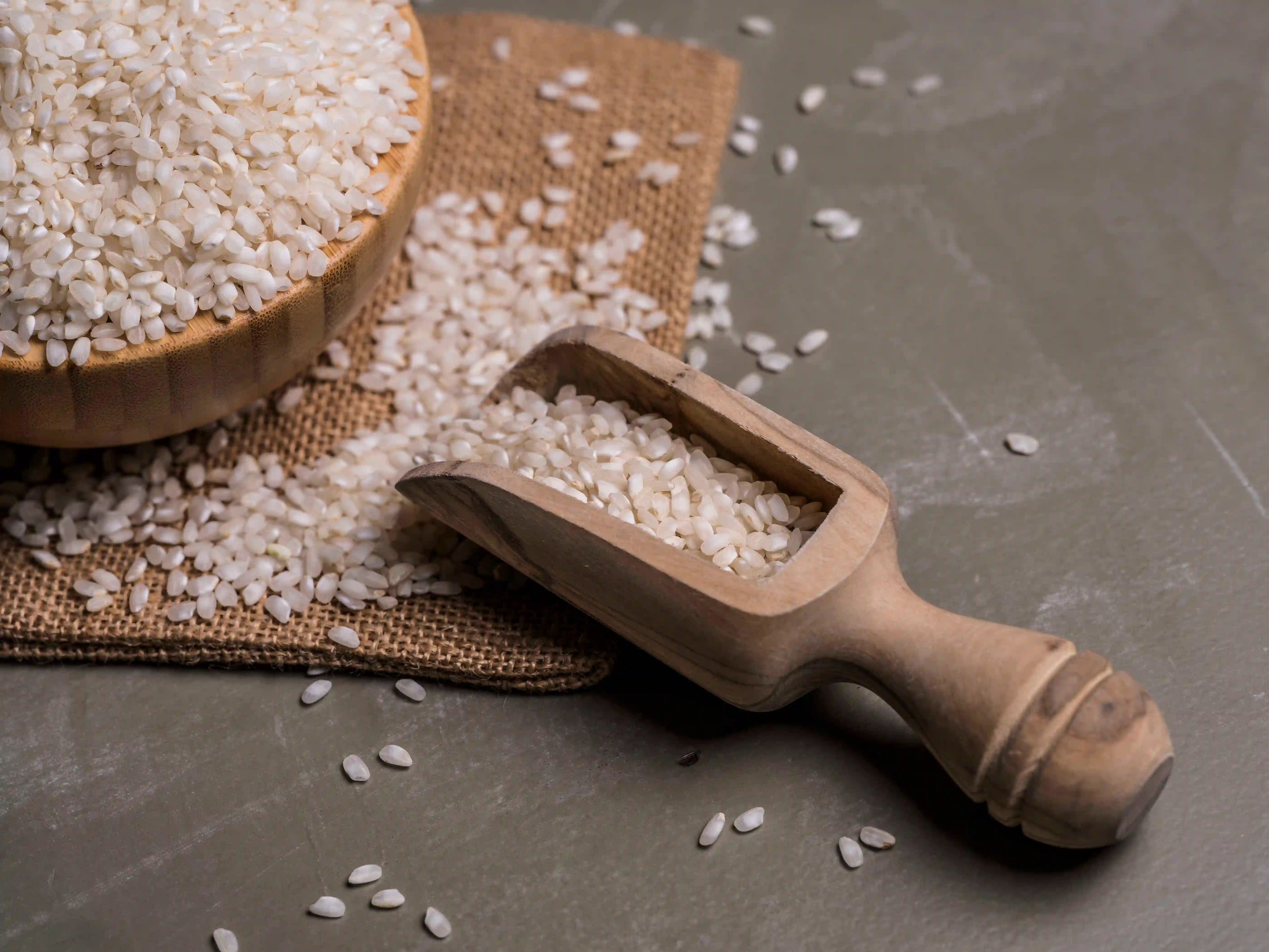 Raw rice grains on wooden palette